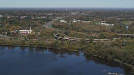 5.7K aerial stock footage of flying by the State Route 370 interchange by the lake in Syracuse, New York Aerial Stock Footage | DX0002_211_039