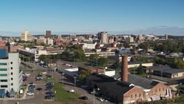 5.7K aerial stock footage fly over building with smoke stack toward the city's downtown area, Downtown Syracuse, New York Aerial Stock Footage | DX0002_212_033