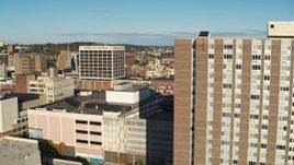 5.7K aerial stock footage of flying by an apartment building to reveal office buildings, Downtown Syracuse, New York Aerial Stock Footage | DX0002_213_022