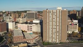 5.7K aerial stock footage of passing by office buildings to reveal an apartment high-rise, Downtown Syracuse, New York Aerial Stock Footage | DX0002_213_025