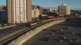 5.7K aerial stock footage reverse view and orbit of a train in Downtown Syracuse, New York Aerial Stock Footage | DX0002_214_005