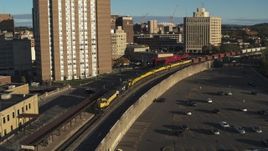 5.7K aerial stock footage orbit and approach a train in Downtown Syracuse, New York Aerial Stock Footage | DX0002_214_006