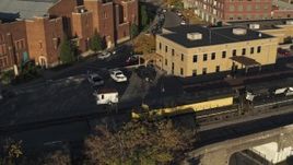 5.7K aerial stock footage tracking a train in Downtown Syracuse, New York Aerial Stock Footage | DX0002_214_007