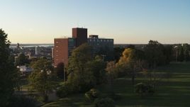 5.7K aerial stock footage focus on Booth Hall while descending at Syracuse University at sunset, New York Aerial Stock Footage | DX0002_214_014