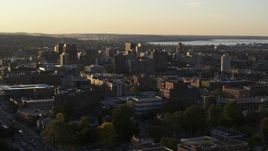 5.7K aerial stock footage of flying by downtown seen from Syracuse University at sunset, New York Aerial Stock Footage | DX0002_214_016