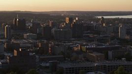 5.7K aerial stock footage of flying by office buildings in Downtown Syracuse at sunset, New York Aerial Stock Footage | DX0002_214_024