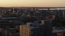 5.7K aerial stock footage of Downtown Syracuse at sunset, seen while descending next to dormitory building, New York Aerial Stock Footage | DX0002_214_025