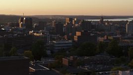 5.7K aerial stock footage of Downtown Syracuse at sunset, seen while flying by dormitory buildings, New York Aerial Stock Footage | DX0002_214_026
