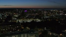 5.7K aerial stock footage of city buildings in Downtown Syracuse at twilight while flying by university, New York Aerial Stock Footage | DX0002_215_006