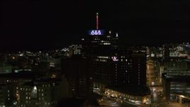 5.7K aerial stock footage of flying away from office tower and hotel at night, Downtown Syracuse, New York Aerial Stock Footage | DX0002_215_035