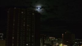 5.7K aerial stock footage of the moon while flying by apartment building, Downtown Syracuse, New York Aerial Stock Footage | DX0002_215_043