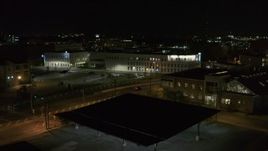 5.7K aerial stock footage of flying away from an office building at night, Downtown Syracuse, New York Aerial Stock Footage | DX0002_215_046