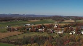 5.7K aerial stock footage reverse view of a church and farm fields in the small town of Orwell, Vermont Aerial Stock Footage | DX0002_217_004