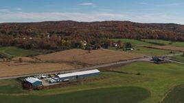5.7K aerial stock footage descend and flyby a country road beside a small town in autumn, Orwell, Vermont Aerial Stock Footage | DX0002_217_011