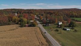 5.7K aerial stock footage flyby a country road beside a small town in autumn, Orwell, Vermont Aerial Stock Footage | DX0002_217_012