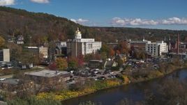 5.7K aerial stock footage ascend from tree to reveal the state capitol building across the river, Montpelier, Vermont Aerial Stock Footage | DX0002_218_012