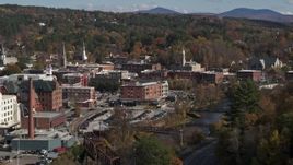 5.7K aerial stock footage of flying by office buildings by the river, Montpelier, Vermont Aerial Stock Footage | DX0002_218_028