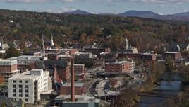 5.7K aerial stock footage of passing by office buildings by the river, Montpelier, Vermont Aerial Stock Footage | DX0002_218_029