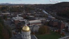5.7K aerial stock footage of flying over the Vermont State House dome toward brick buildings in Montpelier Aerial Stock Footage | DX0002_219_007