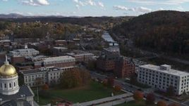 5.7K aerial stock footage ascend with view of government and brick buildings near the river, reveal capitol, Montpelier, Vermont Aerial Stock Footage | DX0002_219_014