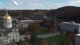 5.7K aerial stock footage a view of government and brick buildings near the river while descending by the capitol, Montpelier, Vermont Aerial Stock Footage | DX0002_219_016