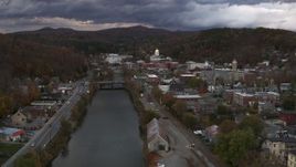 5.7K aerial stock footage of flying by the river with a view of the state capitol at sunset, Montpelier, Vermont Aerial Stock Footage | DX0002_220_016