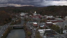 5.7K aerial stock footage of flying over a bridge on the river with a view of the state capitol at sunset, Montpelier, Vermont Aerial Stock Footage | DX0002_220_018