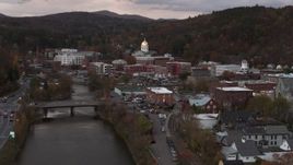 5.7K aerial stock footage descend by the river with a view of the capitol dome at sunset, Montpelier, Vermont Aerial Stock Footage | DX0002_220_026