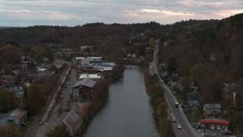 5.7K aerial stock footage of a stationary view of the river and Berlin Street at sunset, Montpelier, Vermont Aerial Stock Footage | DX0002_220_036