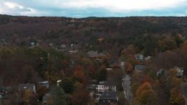 5.7K aerial stock footage of an orbit of homes on a hill with colorful trees at sunset, Montpelier, Vermont Aerial Stock Footage | DX0002_220_041