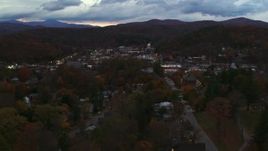 5.7K aerial stock footage of a view of the downtown area of the city seen from homes and fall trees at twilight, Montpelier, Vermont Aerial Stock Footage | DX0002_220_053