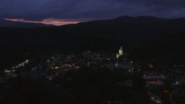 5.7K aerial stock footage of flying by the capitol dome lit up at twilight and downtown buildings, Montpelier, Vermont Aerial Stock Footage | DX0002_220_061