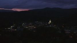 5.7K aerial stock footage of flying by downtown buildings around the capitol dome lit up at twilight, Montpelier, Vermont Aerial Stock Footage | DX0002_220_062