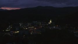 5.7K aerial stock footage of passing by city buildings around the capitol dome lit up at twilight, Montpelier, Vermont Aerial Stock Footage | DX0002_220_063