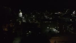 5.7K aerial stock footage of the Vermont State Capitol behind a dark building at night, Montpelier, Vermont Aerial Stock Footage | DX0002_221_017