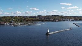 5.7K aerial stock footage of passing a marina on Lake Champlain, reveal lighthouse, Burlington, Vermont Aerial Stock Footage | DX0002_222_020