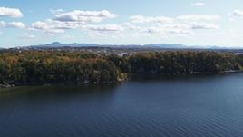 5.7K aerial stock footage of a reverse view of forest on the shore of Lake Champlain, Burlington, Vermont Aerial Stock Footage | DX0002_223_006