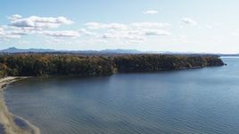 5.7K aerial stock footage of a reverse view of forest on Lone Rock Point by Lake Champlain, and descend, Burlington, Vermont Aerial Stock Footage | DX0002_223_007