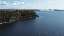 5.7K aerial stock footage ascend away from forest on the tip of Lone Rock Point by Lake Champlain, Burlington, Vermont Aerial Stock Footage | DX0002_223_024