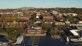 5.7K aerial stock footage of a reverse view of city buildings near marinas, Burlington, Vermont Aerial Stock Footage | DX0002_224_058