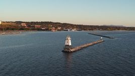5.7K aerial stock footage fly low over Lake Champlain lighthouse toward downtown at sunset, Burlington, Vermont Aerial Stock Footage | DX0002_225_008