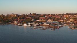 5.7K aerial stock footage fly away from and orbit buildings in downtown behind marinas at sunset, Burlington, Vermont Aerial Stock Footage | DX0002_225_012