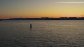 5.7K aerial stock footage of flying away from a sailboat on Lake Champlain at twilight, Burlington, Vermont Aerial Stock Footage | DX0002_225_036