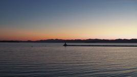 5.7K aerial stock footage of flying low toward lighthouse on Lake Champlain at twilight, Burlington, Vermont Aerial Stock Footage | DX0002_226_001