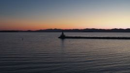 5.7K aerial stock footage of flying low to approach and fly over lighthouse on Lake Champlain at twilight, Burlington, Vermont Aerial Stock Footage | DX0002_226_002