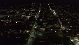 5.7K aerial stock footage orbit office buildings around College Street lit up for nighttime, Burlington, Vermont Aerial Stock Footage | DX0002_226_036