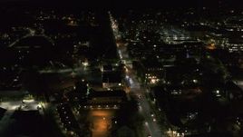 5.7K aerial stock footage circling and flying away from office buildings on Battery Street lit up for nighttime, Burlington, Vermont Aerial Stock Footage | DX0002_226_038
