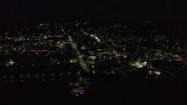5.7K aerial stock footage of flying away from and orbiting office buildings and streets in downtown lit up for nighttime, Burlington, Vermont Aerial Stock Footage | DX0002_226_042