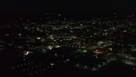 5.7K aerial stock footage of circling around city buildings in downtown lit up for nighttime, Burlington, Vermont Aerial Stock Footage | DX0002_226_044