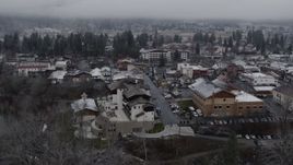 5.7K aerial stock footage orbit rooftops dusted with snow in the small town, Leavenworth, Washington Aerial Stock Footage | DX0002_227_010
